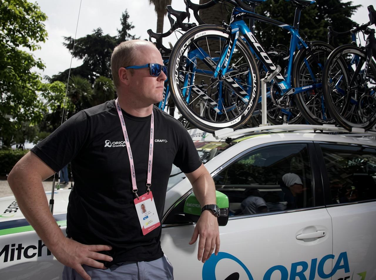 Dan Jones beside the Orica GreenEDGE team car